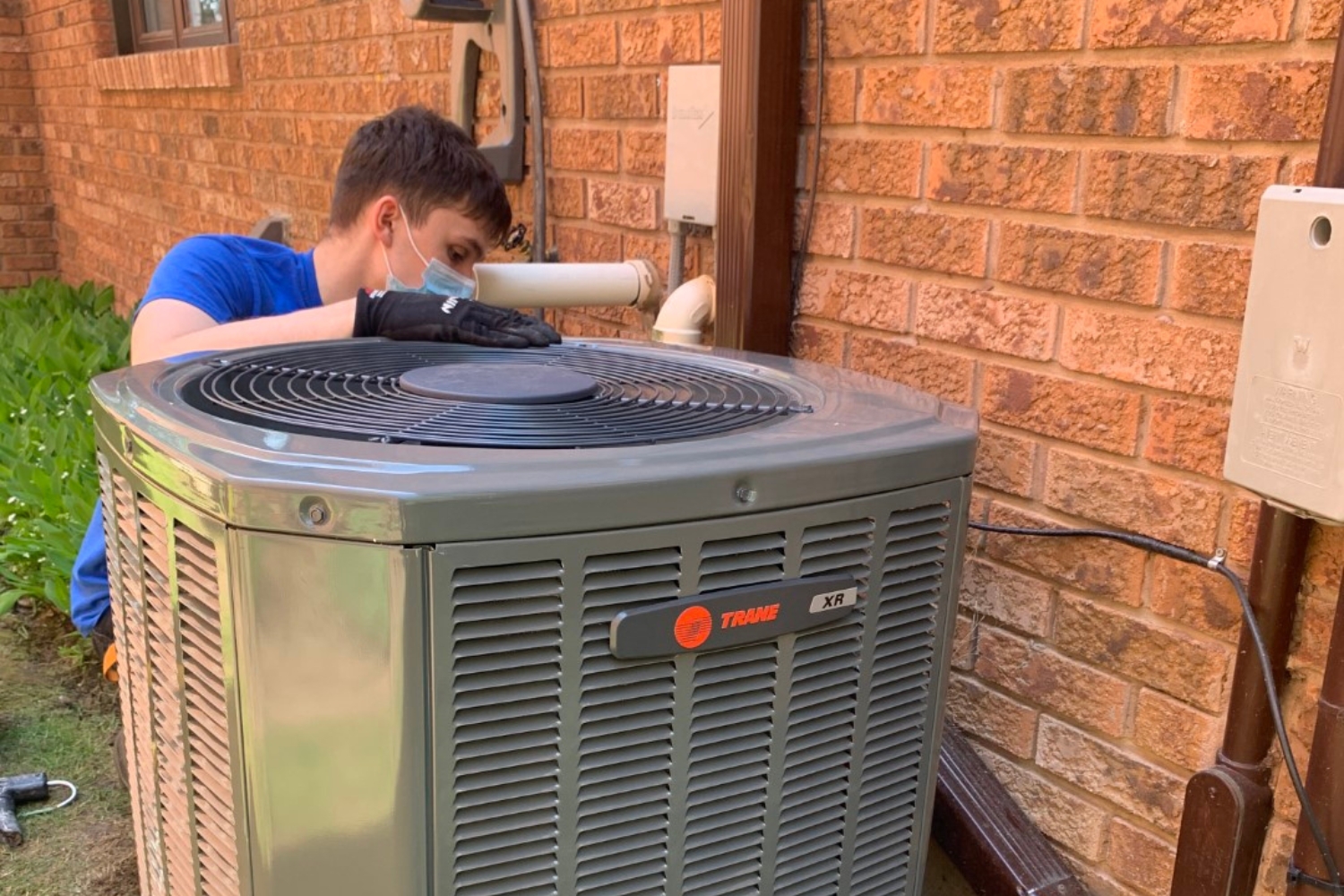 hvac professional installing ac unit outside