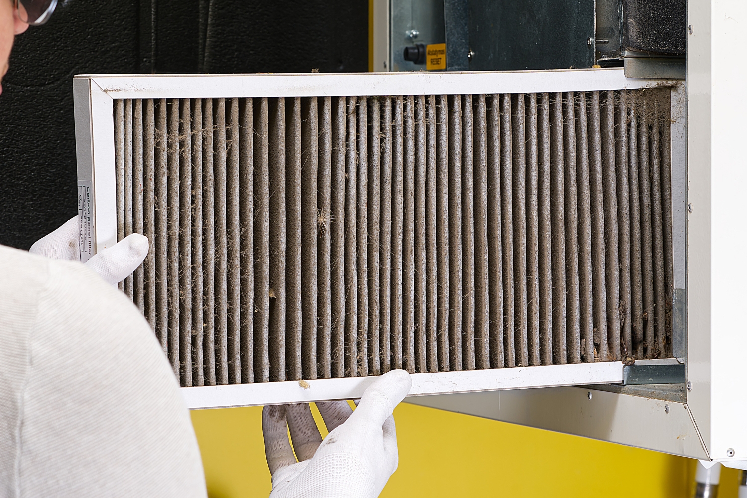professional replacing HVAC filters