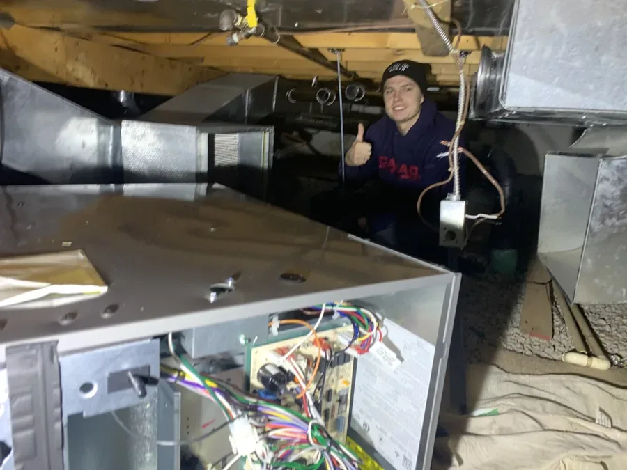 NorthWind HVAC technician inspecting and servicing residential ductwork in a Toronto area home