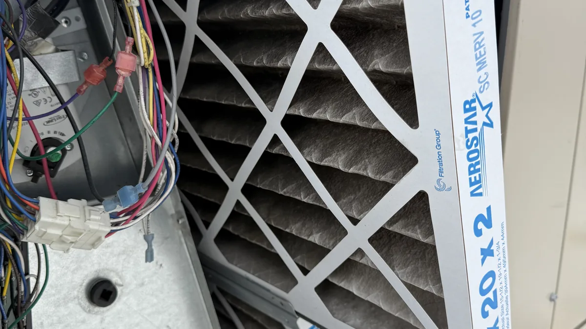 HVAC technician inspecting furnace burner assembly during GTA furnace repair call in Toronto Ontario